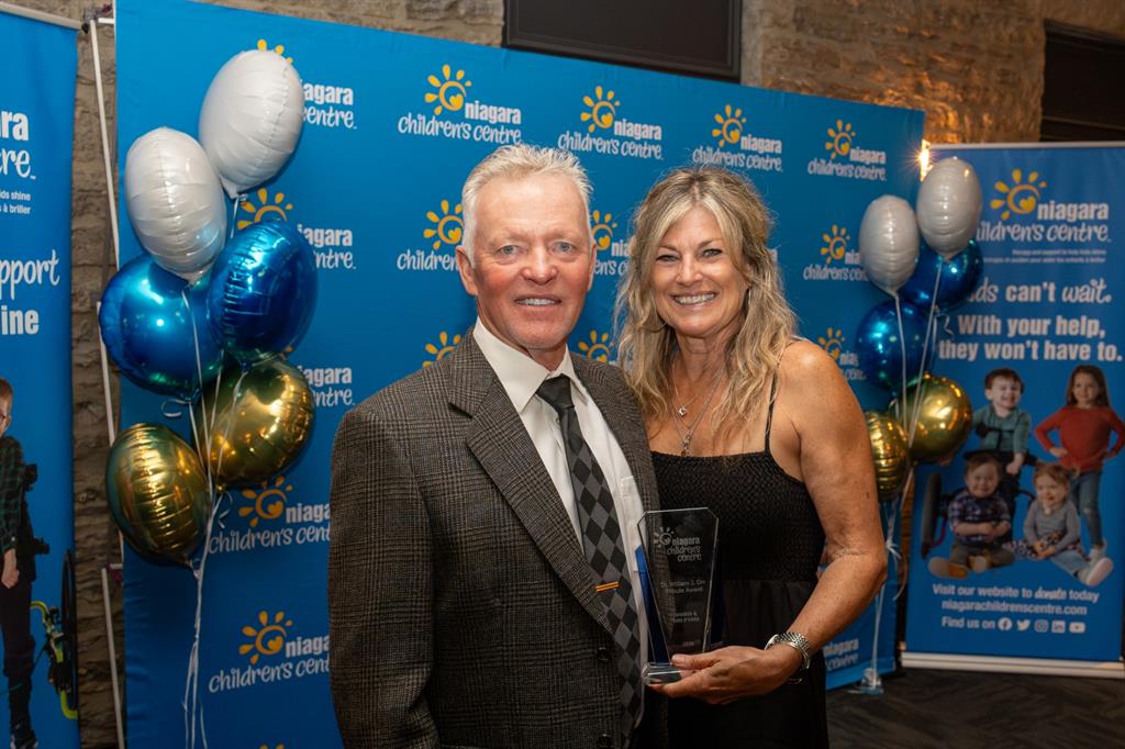 Man and women holding an award